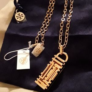 Tory Burch fitbit gold color pendent.